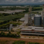 Large livestock feed pellet production line plant aerial view with silos and factory buildings